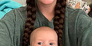 Elias is registered to the contest to win money with this photo: baby, child, woman, smile, braids, indoor, portrait, person, clothing, overalls, white_shirt, happy, cute, seated, face, head, closeup, background, cushion, cozy