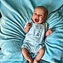 baby, infant, blue_blanket, overalls, smiling, happy, cute, face, child, lying_down, clothing, texture, soft, skin, feet, hands, expression, indoors, portrait, young