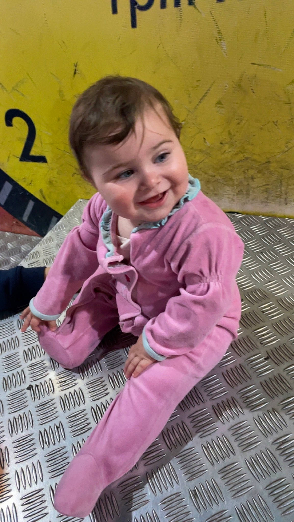 Zelyana participe au concours pour gagner de l'argent avec cette photo : baby, baby_toddler_clothing, cheek, child, flooring, fun, grass, happy, joy, leisure, magenta, outerwear, pattern, person, pink, play, purple, sitting, skin, sleeve