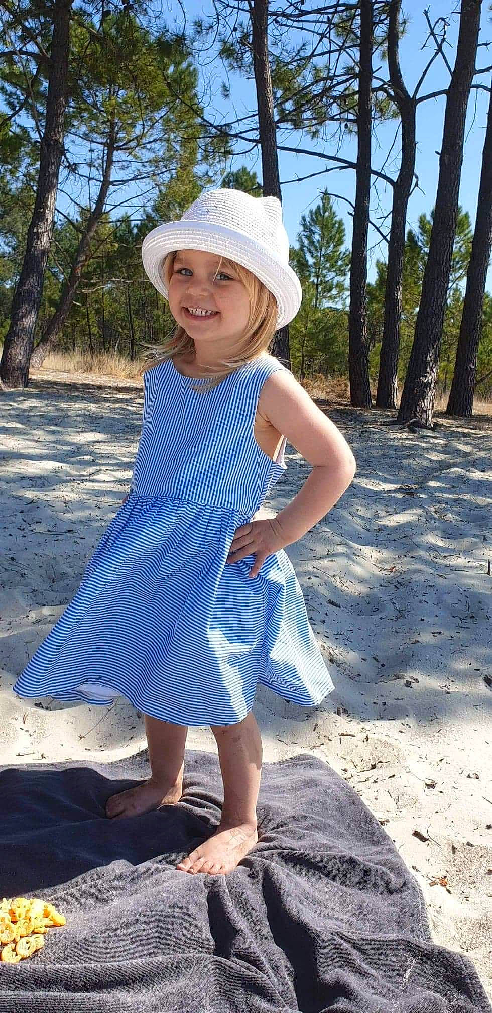 Maëly a rejoint le concours — aidez-le/la à gagner de superbes lots ! ankle, baby_toddler_clothing, barefoot, blond, blue, clothing, costume_accessory, day_dress, denim, dress, electric_blue, foot, hat, headgear, headwear, joy, one_piece_garment, people_in_nature, person, summer