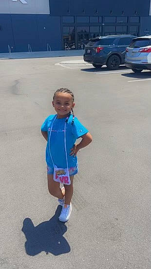 Dayonna joined the competition — help win amazing prizes! asphalt, automotive_design, automotive_exterior, automotive_lighting, automotive_tire, bumper, car, electric_blue, joy, leisure, motor_vehicle, pedestrian, person, recreation, road, road_surface, shorts, sidewalk, t_shirt, tire