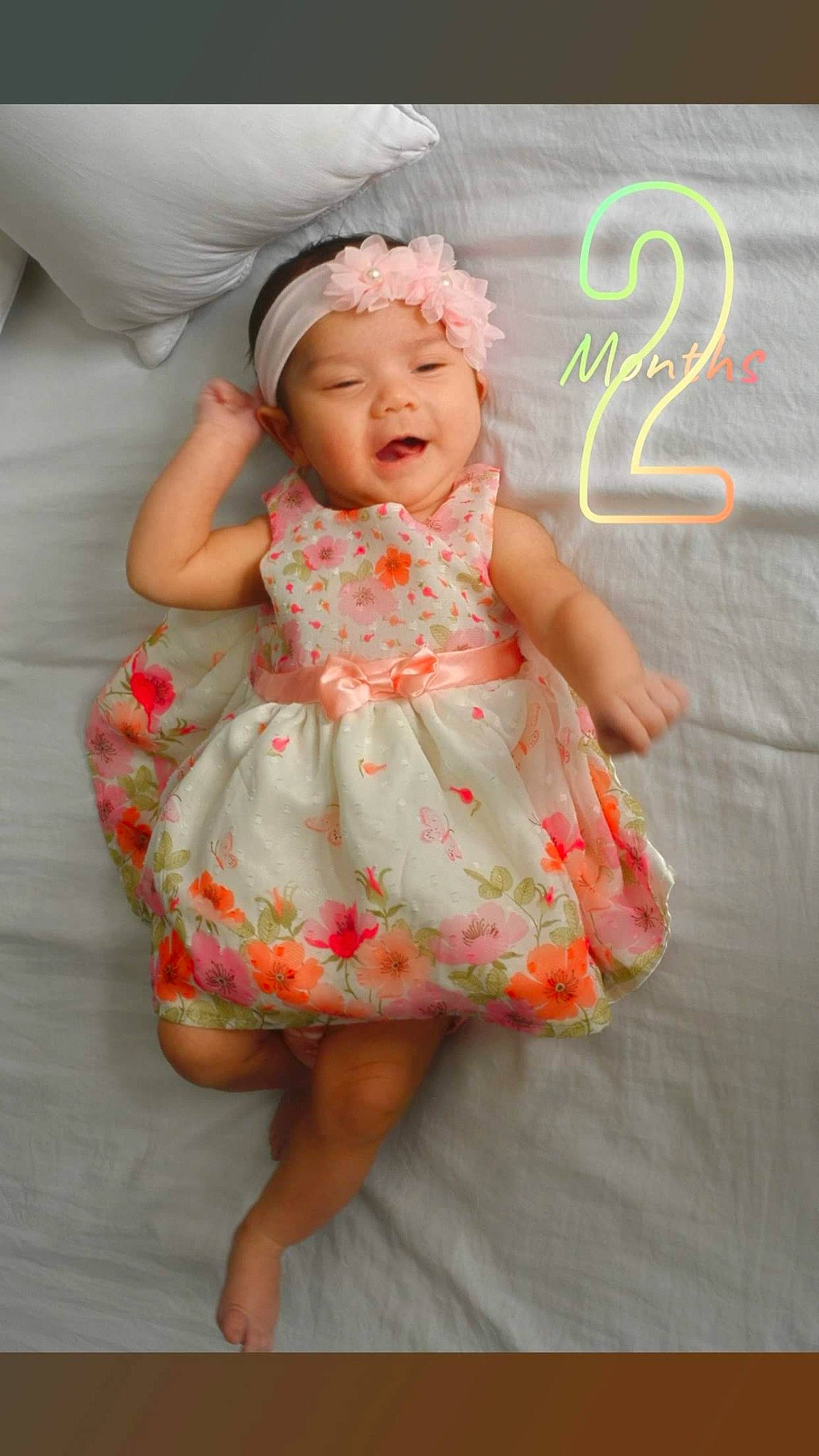 Amaris joined the competition — help win amazing prizes! baby, baby_toddler_clothing, child, clothing, dress, hair_accessory, headgear, headwear, orange, pattern, peach, person, pink, smile, toddler