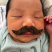 Theodore joined the competition — help win amazing prizes! newborn, baby, sleeping, mustache, funny, portrait, close_up, face, eyes_closed, infant, dinosaur, onesie, clothing, bedding, blanket, indoors, hand, resting, peaceful, humorous