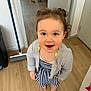 Juliette participe au concours pour gagner de l'argent avec cette photo : toddler, child, barefoot, curly_hair, striped_dress, cardigan, wooden_floor, broom, indoor, smiling, person, standing, happy, brown_eyes, hair_tied, home, door, floor, room, casual