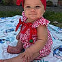 baby, blanket, child, cute, earrings, foot, gingham, grass, hand, headband, infant, outdoor, pattern, person, plaid, portrait, red, sitting, smile, summer