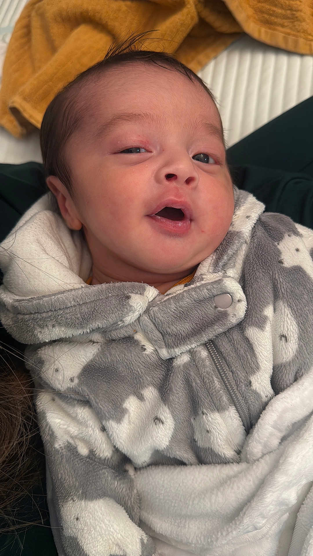 Khlil is registered to the contest to win money with this photo: baby, infant, face, clothing, onesie, bunny_pattern, gray, white, soft_fabric, blanket, warm, cute, expression, cozy, portrait, newborn, child, indoor, closeup, person