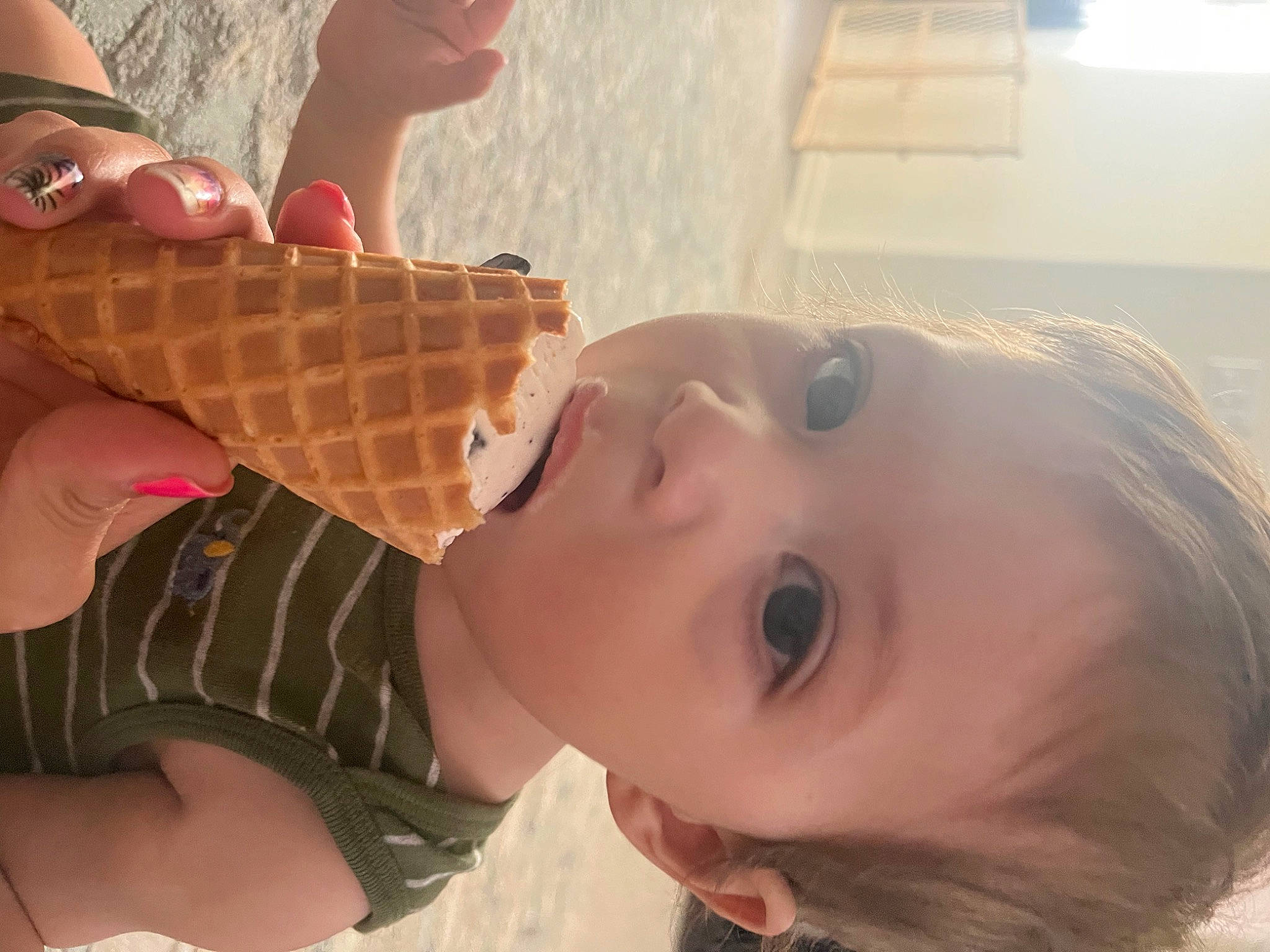 Marcus is registered to the contest to win money with this photo: baby, brown_hair, child, eyelash, fawn, fun, happy, ice_cream, ice_cream_cone, mouth, nail, neck, nose, pattern, peach, person, skin, smile, surprise, toddler
