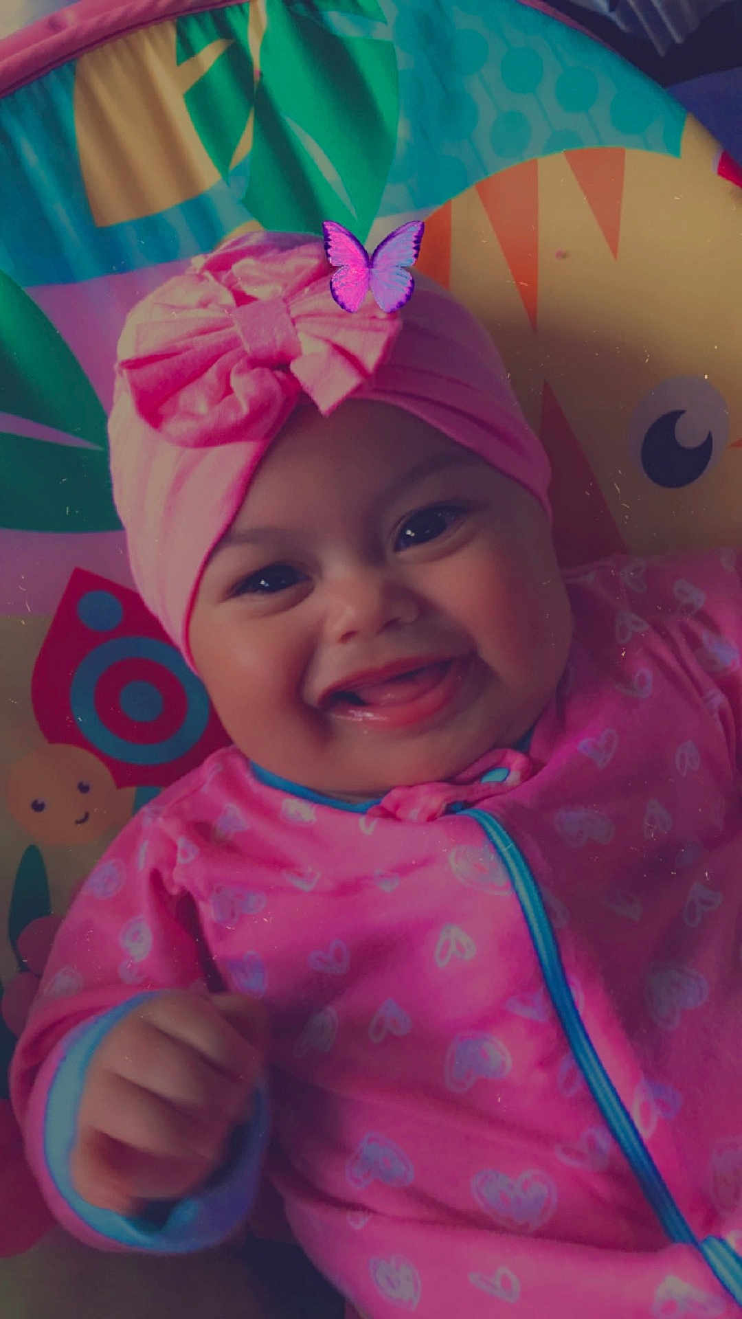 Chrisnery Sue joined the competition — help win amazing prizes! baby, baby_girl, bow, butterfly_filter, cheerful, child, closeup, colorful_background, cute, face, hand, happy, headwrap, indoor, infant, person, pink_clothing, playful, portrait, smiling