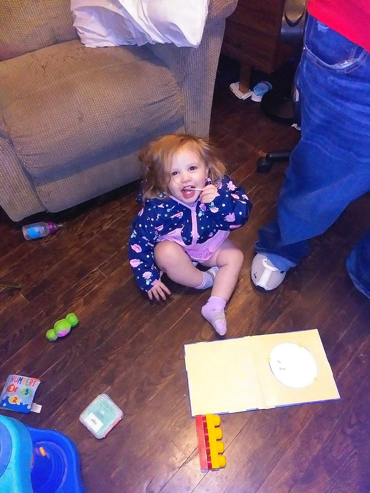 Aspen is registered to the contest to win money with this photo: baby, baby_toddler_clothing, blue, child, comfort, electric_blue, finger, floor, flooring, fun, hardwood, light, person, purple, sitting, smile, standing, toddler, varnish, white