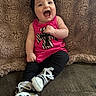 Raekyn is registered to the contest to win money with this photo: baby, child, smiling, laughing, pink_top, black_headband, black_leggings, white_shoes, polka_dot, couch, blanket, cozy, indoor, happy, person, portrait, sitting, cute, infant, apparel