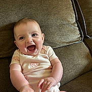 Raekyn joined the competition — help win amazing prizes! baby, infant, smile, happy, couch, furniture, indoor, child, cute, person, skin, face, hands, sitting, apparel, short_sleeve, home, relax, joy, playful