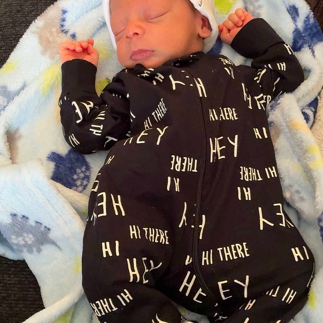 Zeovoni joined the competition — help win amazing prizes! baby, blanket, child, clothing, couch, cozy, cute, fabric, face, footed_pajamas, headwear, indoor, infant, newborn, onesie, patterned_clothing, peaceful, resting, sleeping, soft