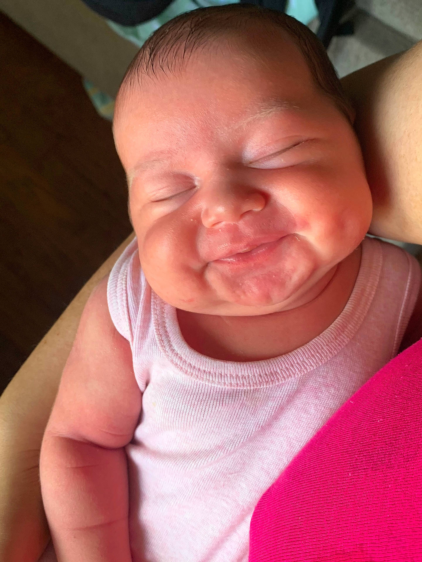 arm, baby, cheeks, child, closeup, clothing, cute, dimples, face, holding, indoors, infant, newborn, onesie, peaceful, person, portrait, skin, sleeping, smiling