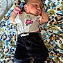 baby, newborn, sleeping, infant, blanket, monkey_pattern, clothing, shirt, pants, socks, cute, peaceful, resting, indoors, child, soft, cozy, lying_down, portrait, adorable