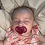 Raya is registered to the contest to win money with this photo: baby, pacifier, sleeping, infant, floral_outfit, bed, blanket, child, peaceful, cute, soft_lighting, pale_skin, relaxation, indoors, portrait, head, face, closed_eyes, rest, comfort