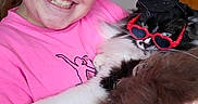 Oreo is registered to the contest to win money with this photo: animal, black_and_white, cat, child, cute, fluffy_cat, fun, furry, girl, glasses, happy, hat, holding, human, indoor, pet, pink_shirt, playful, portrait, smiling