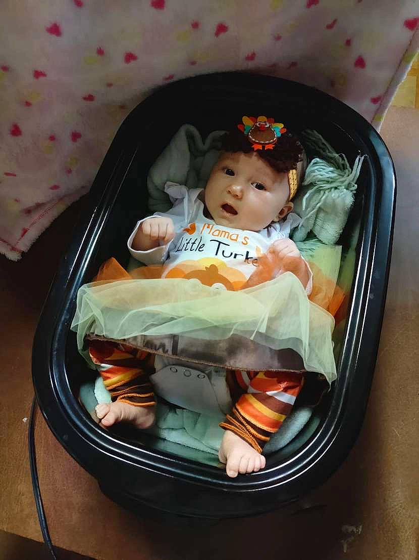 Leah is registered to the contest to win money with this photo: baby, baby_carriage, baby_products, baby_toddler_clothing, baby_toys, bag, baggage, basket, box, child, comfort, cradle, fashion_accessory, headwear, infant_bed, luggage_and_bags, person, sitting, sweetness, toddler