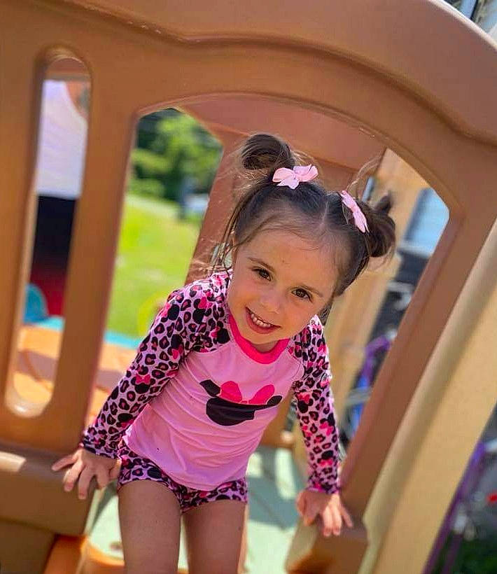 Paisley joined the competition — help win amazing prizes! baby_toddler_clothing, brown_hair, child, eyewear, fun, grass, happy, joy, leisure, magenta, outdoor_play_equipment, person, personal_protective_equipment, pink, play, playground, recreation, shorts, smile, sunglasses