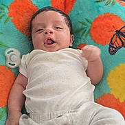 Julian joined the competition — help win amazing prizes! baby, infant, blanket, pineapple_pattern, butterfly_pattern, white_clothing, pacifier, lying_down, cute, smiling, indoors, soft_toy, child, face, head, hand, legs, fabric, colorful, comfortable
