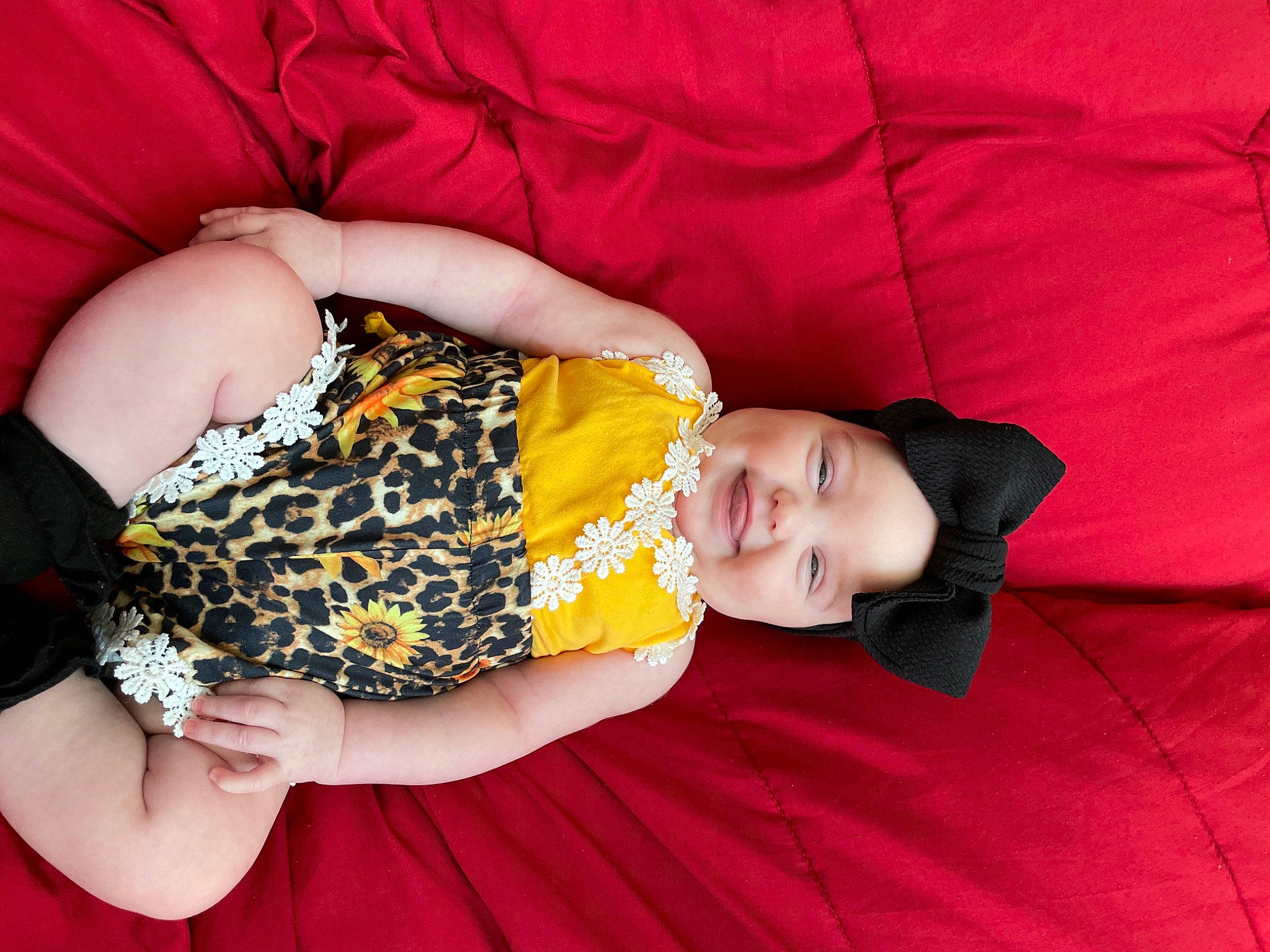 Kaiyani is registered to the contest to win money with this photo: baby_toddler_clothing, comfort, couch, day_dress, dress, event, eye, glasses, hand, happy, headwear, human_body, human_leg, leg, orange, pattern, person, textile, thigh, toddler