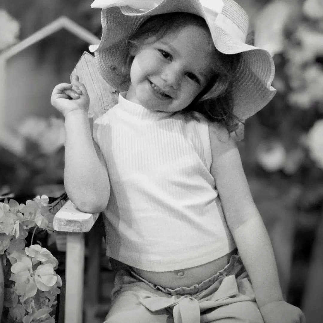 Cassandra joined the competition — help win amazing prizes! baby, bodypart, cap, clothing, face, finger, flower, flowerarrangement, flowerbouquet, happy, hat, head, pants, person, petal, photography, plant, portrait, smile, sunhat
