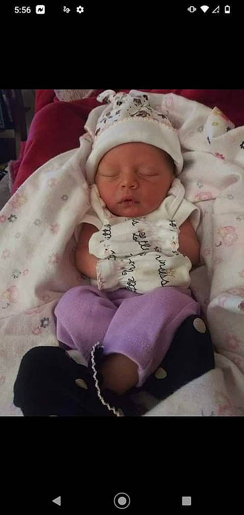 Amarianna Kelly is registered to the contest to win money with this photo: baby, baby_products, baby_sleeping, baby_toddler_clothing, beanie, cheek, child, comfort, embellishment, eye, fashion_accessory, headgear, headwear, iris, linens, magenta, person, pink, purple, sitting