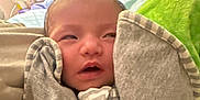 Aleia Rose is registered to the contest to win money with this photo: newborn, baby, infant, clothing, onesie, sleepy, face, hands, wrapped, indoor, person, cute, soft, blanket, toddler, closeup, young, human, portrait, cozy