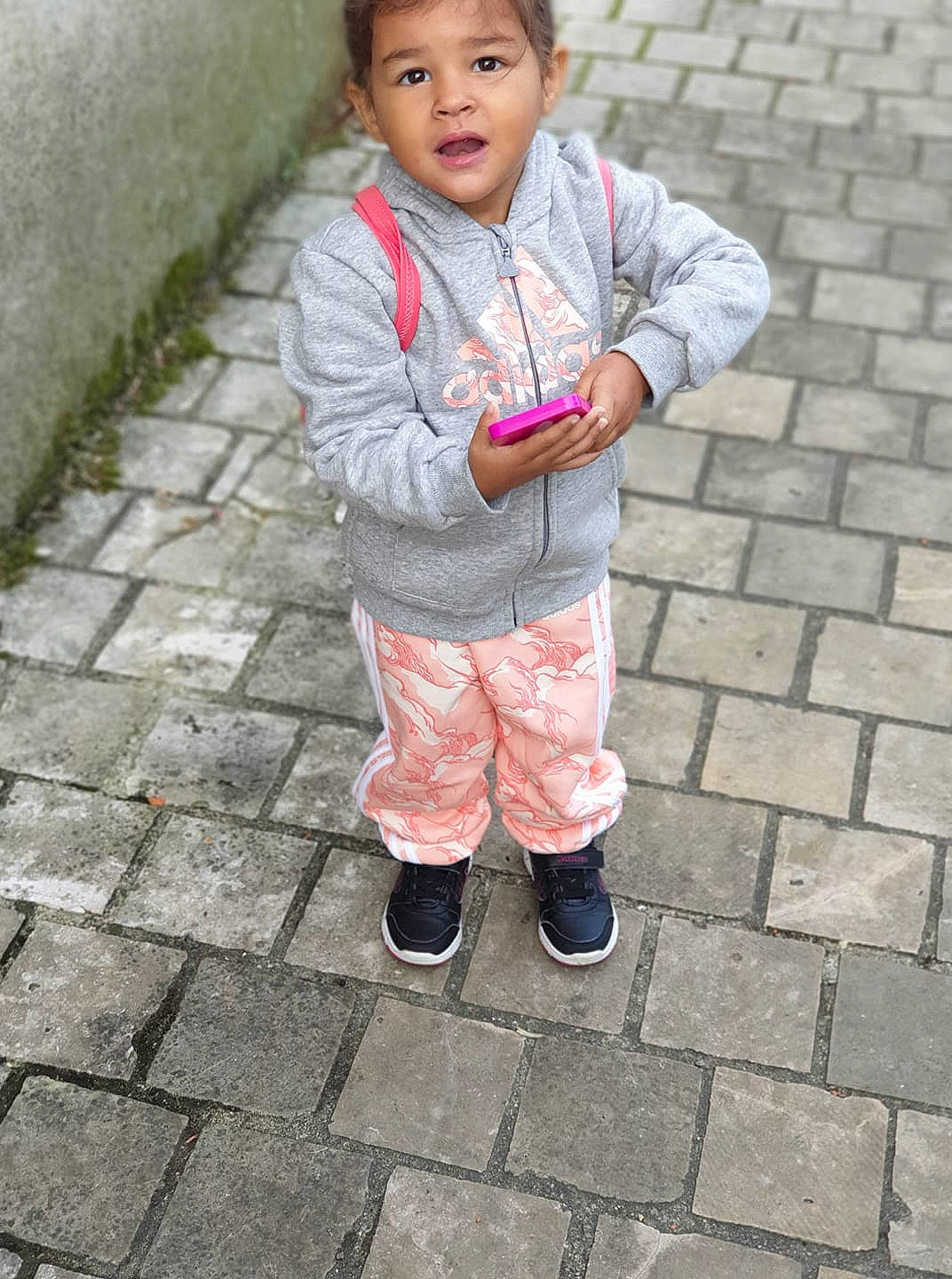 Celia participe au concours pour gagner de l'argent avec cette photo : child, outerwear, person, pink, smile, standing, toddler