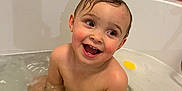 Ollie joined the competition — help win amazing prizes! toddler, child, bathtub, bath, water, bubbles, wet_hair, smiling, happy, skin, bathroom, tiles, soap, personal_care, sitting, playful, young_child, indoors, cute, joyful
