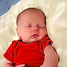 Haze is registered to the contest to win money with this photo: newborn, baby, sleeping, infant, portrait, red_shirt, blanket, white_blanket, fluffy, bed, indoors, peaceful, closed_eyes, face, hands, arms, cozy, resting, photography, cute