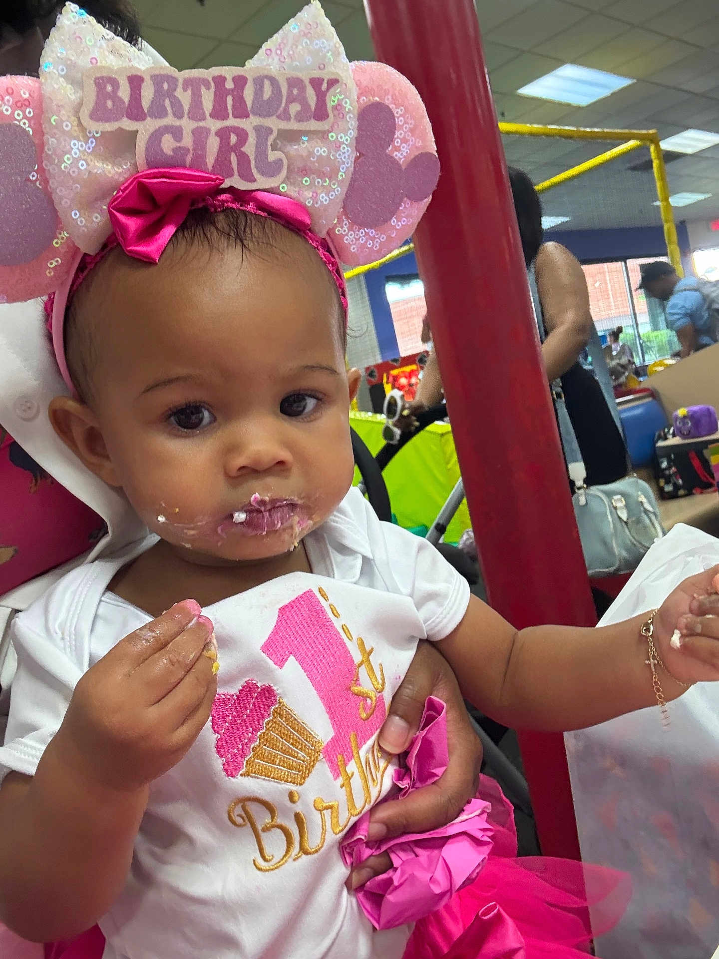 Gianna joined the competition — help win amazing prizes! baby, birthday, birthday_girl, headband, cake, party, indoor, child, face, pink, clothing, celebration, people, hand, food, smear, toddler, person, event, happy
