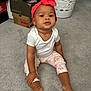Gianna joined the competition — help win amazing prizes! baby, child, sitting, floor, carpet, headwrap, red_headwrap, white_onesie, floral_pants, barefoot, shoe_boxes, laundry_basket, indoor, person, young_child, curious_expression, home, footwear, casual_clothing, cute