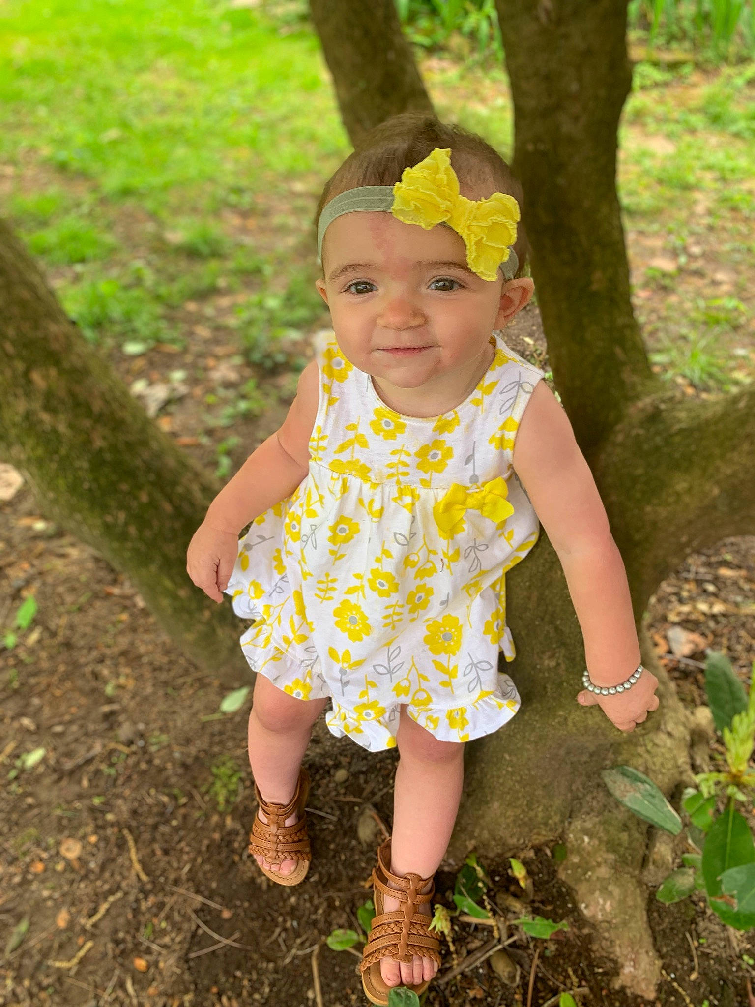 Brayleigh is registered to the contest to win money with this photo: baby_toddler_clothing, child, child_model, design, dress, flower, fun, grass, green, leaf, pattern, person, plant, smile, spring, summer, toddler, tree, vacation, yellow