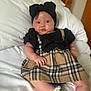 baby, infant, child, bed, pillow, dress, plaid, headband, bow, white, sock, cute, portrait, indoors, furniture, wood, curious, soft, skin, resting