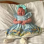 baby, child, blue_dress, headband, bow, smiling, happy, sitting, bed, white_bedspread, infant, cute, portrait, indoor, clothing, sock, hands, face, person, young