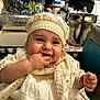 baby, smiling, child, face, hand, clothing, hat, portrait, cute, indoor, people, happy, infant, decorative, fabric, jewelry, person, table, background, blurred
