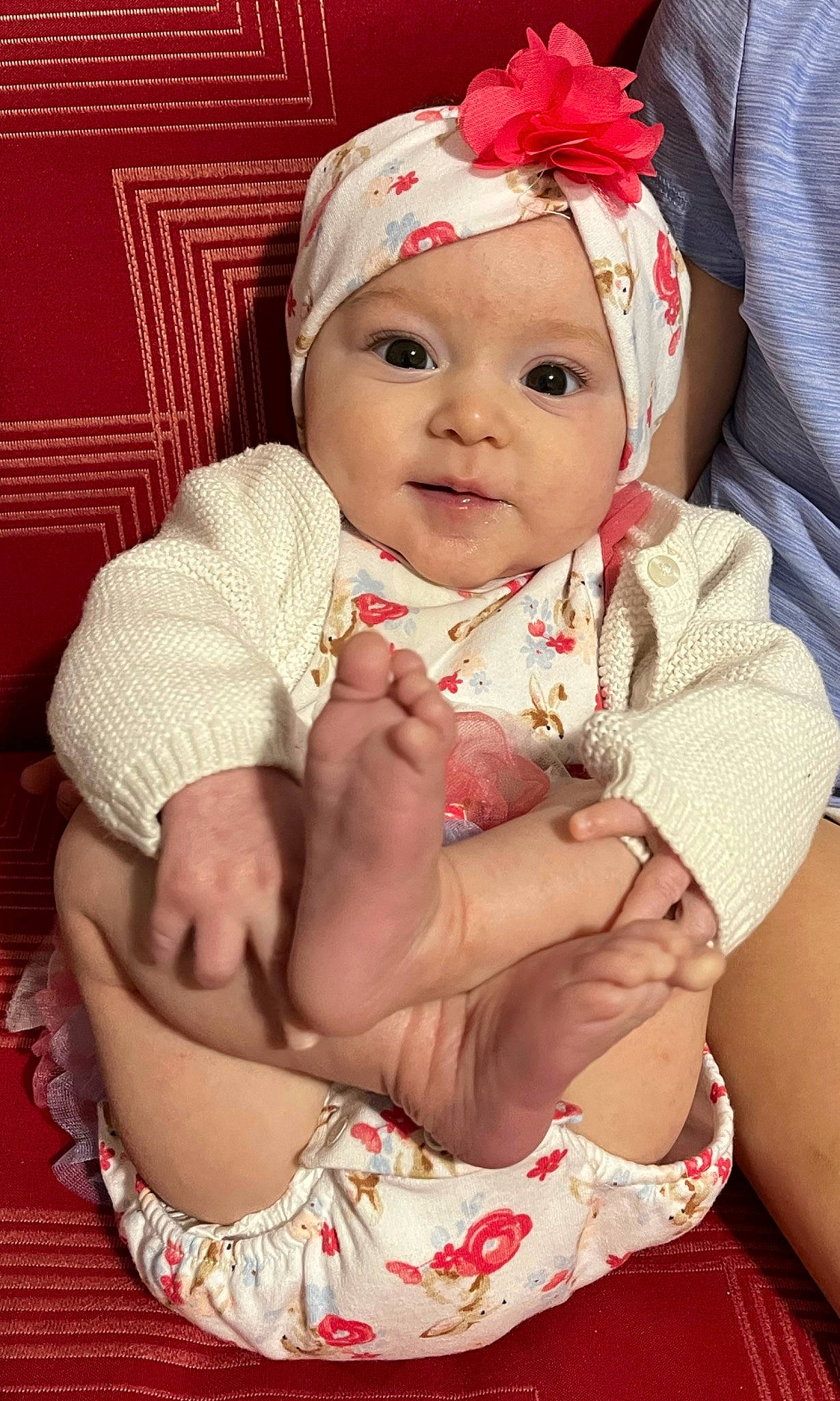 Marcie is registered to the contest to win money with this photo: baby, baby_toddler_clothing, cap, cheek, child, dress, face, fashion_accessory, glasses, happy, hat, headband, headwear, human_leg, lip, pattern, person, pink, skin, smile