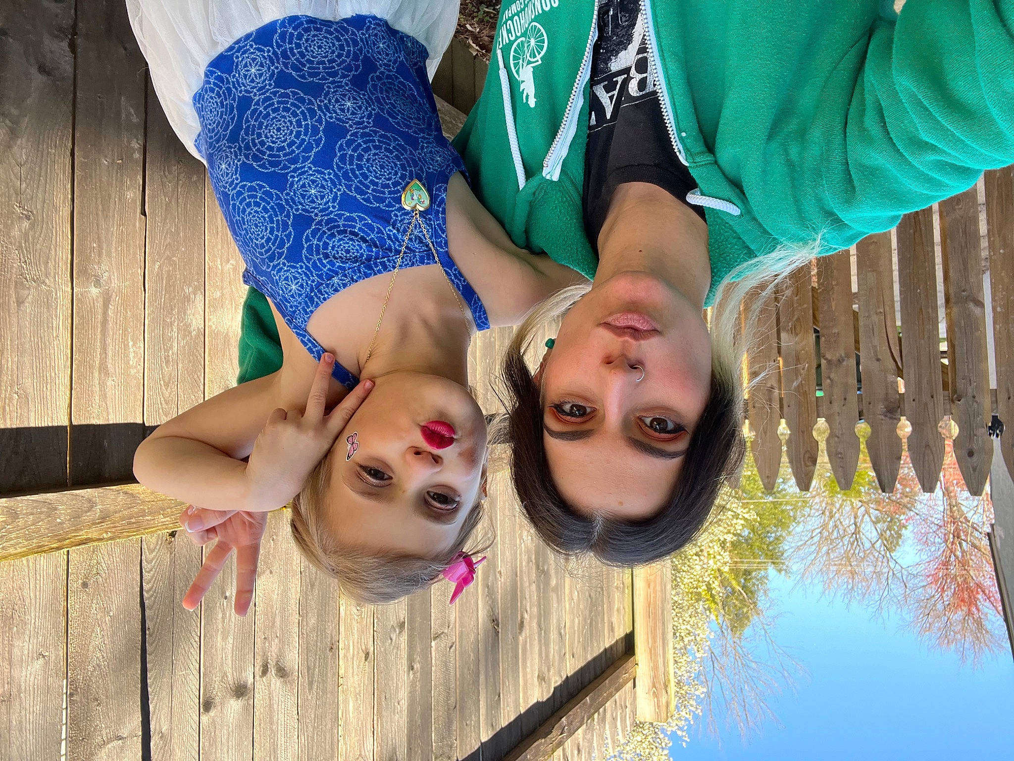 Lilja is registered to the contest to win money with this photo: blue, cool, eye, eyewear, facial_expression, fun, glasses, grass, green, happy, leisure, people_in_nature, person, photograph, plant, red, smile, thigh, tree, wood