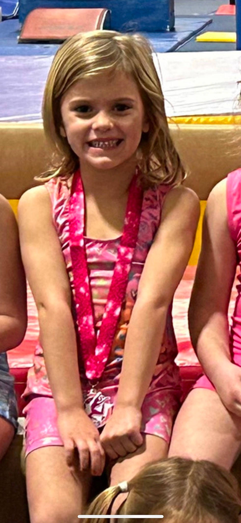 Lilja is registered to the contest to win money with this photo: beauty, black_hair, chest, child, event, fun, hair, happy, head, human_leg, jewellery, joy, leisure, magenta, necklace, person, pink, recreation, sitting, smile