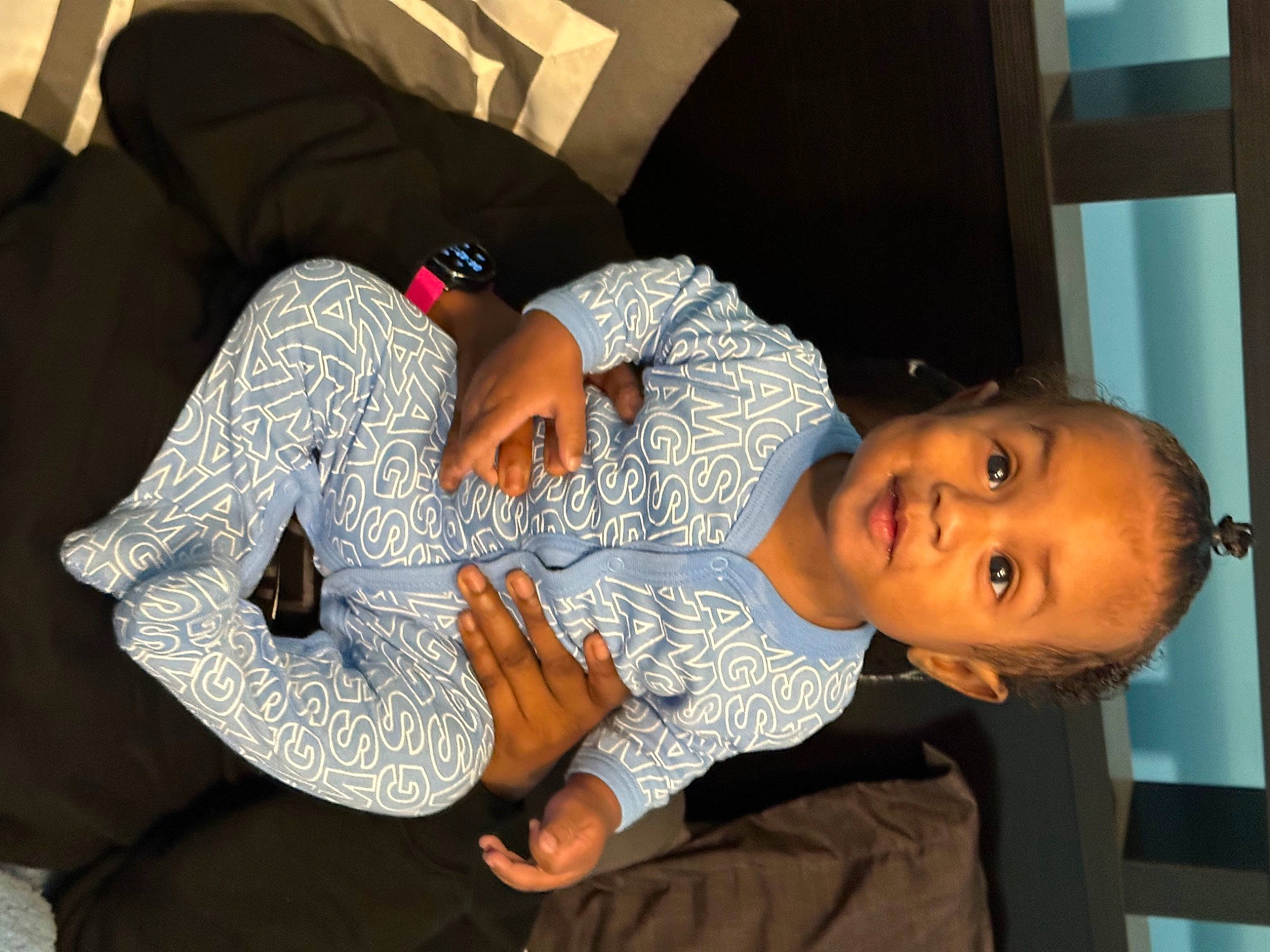 Jayce is registered to the contest to win money with this photo: arm, beauty, child, comfort, elbow, event, finger, fun, happy, human_leg, lap, mammal, person, room, sitting, sleeve, t_shirt, textile, thigh, toddler