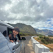 Weston Aydyn joined the competition — help win amazing prizes! car, child, clouds, daytime, greenery, happy, landscape, mountains, nature, outdoor, person, reflection, road, roadside, scenic, sky, smiling, travel, vehicle, window