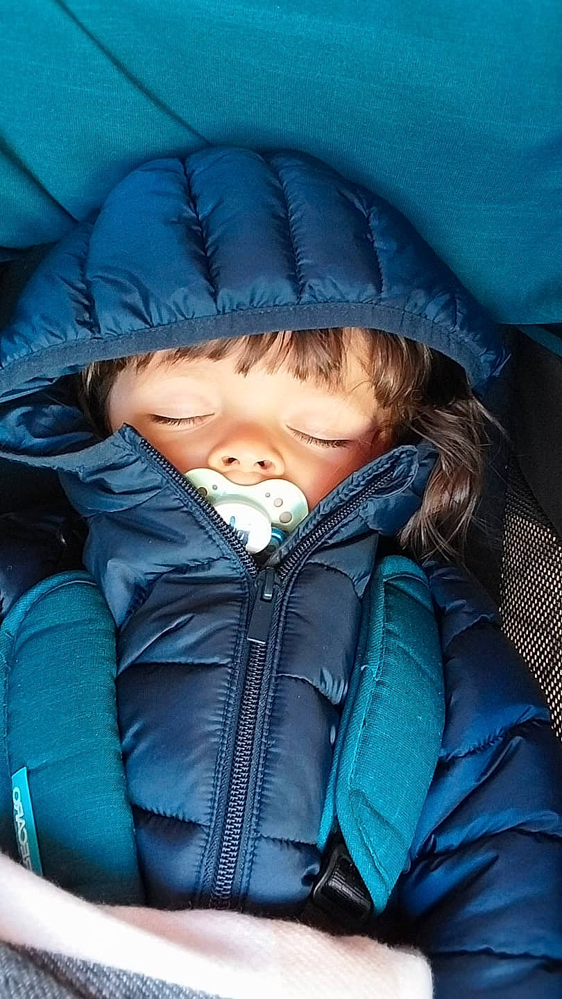 Gabriel participe au concours pour gagner de l'argent avec cette photo : baby, blanket, clothing, coat, cushion, face, hat, head, homedecor, hood, hoodie, jacket, knitwear, pants, person, photography, portrait, sleeping, sweater, sweatshirt