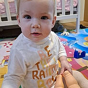 Miya Vieru participe au concours pour gagner de l'argent avec cette photo : baby, child, pink_bow, doll, toy, crib, play_mat, indoor, toddler, clothing, person, face, floor, furniture, hand, sitting, curious, nursery, colorful, young_child