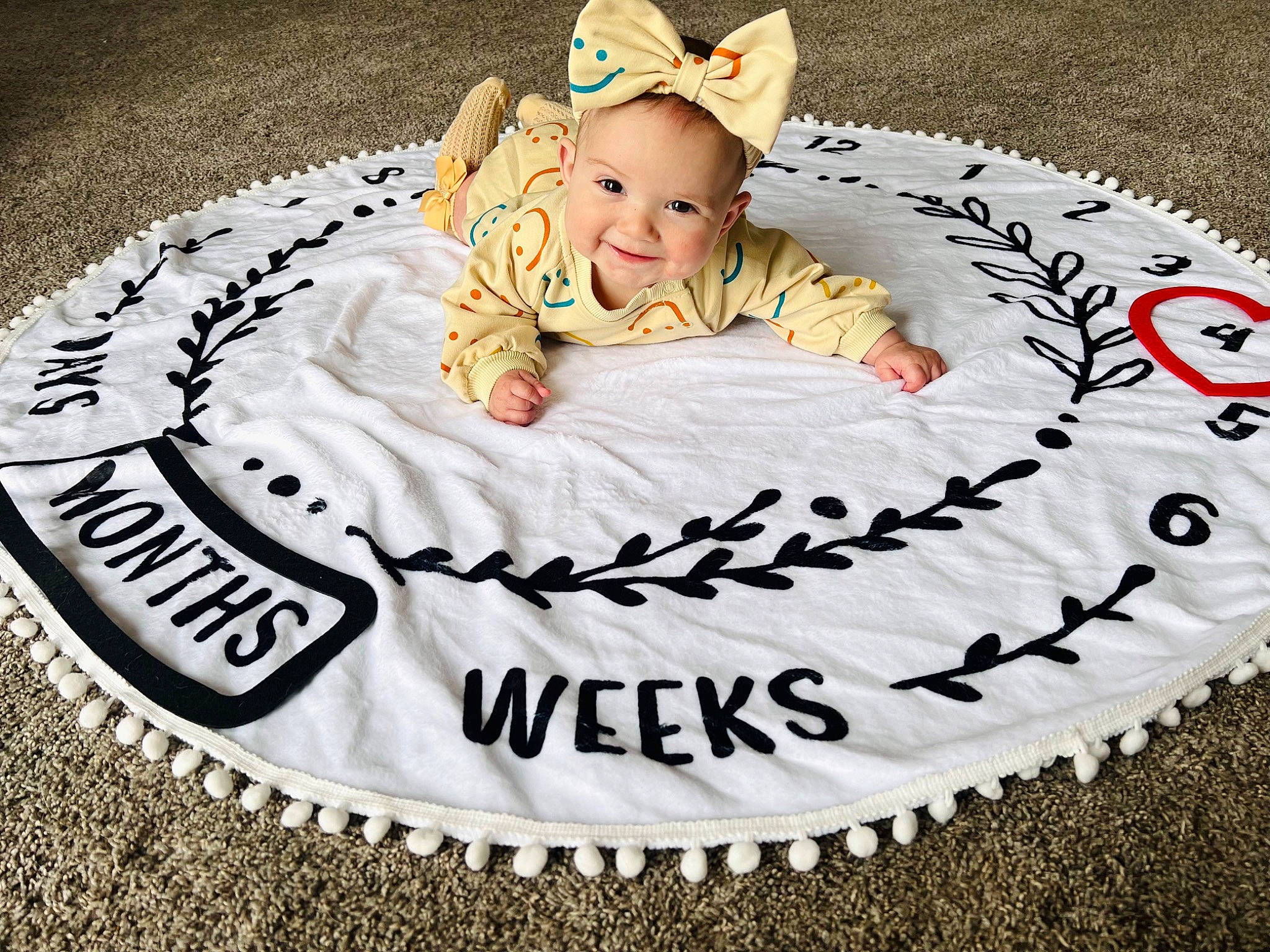 Londyn joined the competition — help win amazing prizes! baby, baby_toddler_clothing, child, circle, comfort, event, font, grass, happy, joy, linens, pattern, person, pink, rectangle, sitting, sleeve, smile, t_shirt, textile
