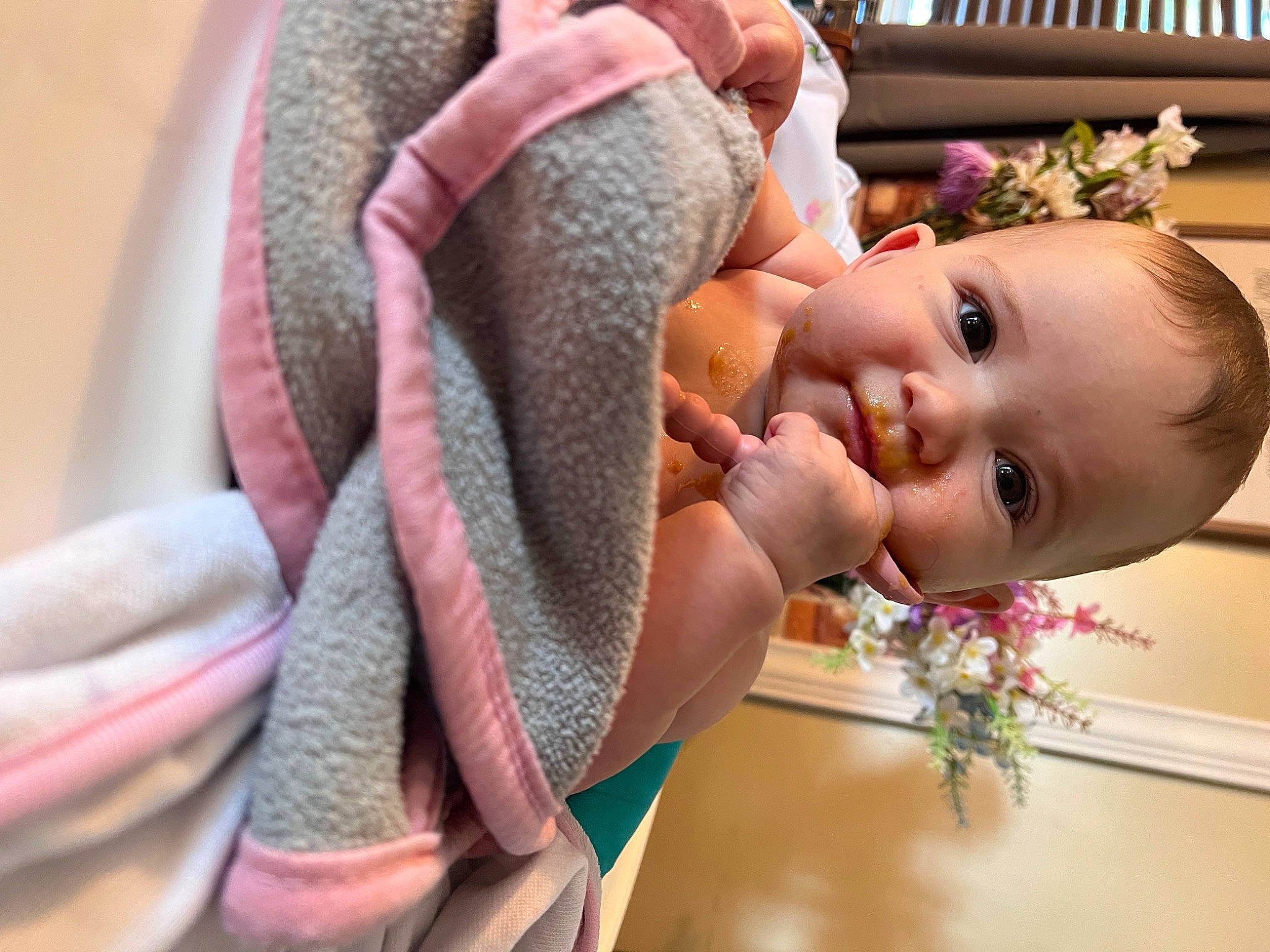 Londyn is registered to the contest to win money with this photo: arm, baby, child, chin, ear, eyebrow, eyelash, gesture, happy, headpiece, human_body, iris, lip, neck, person, pink, plant, skin, smile, textile