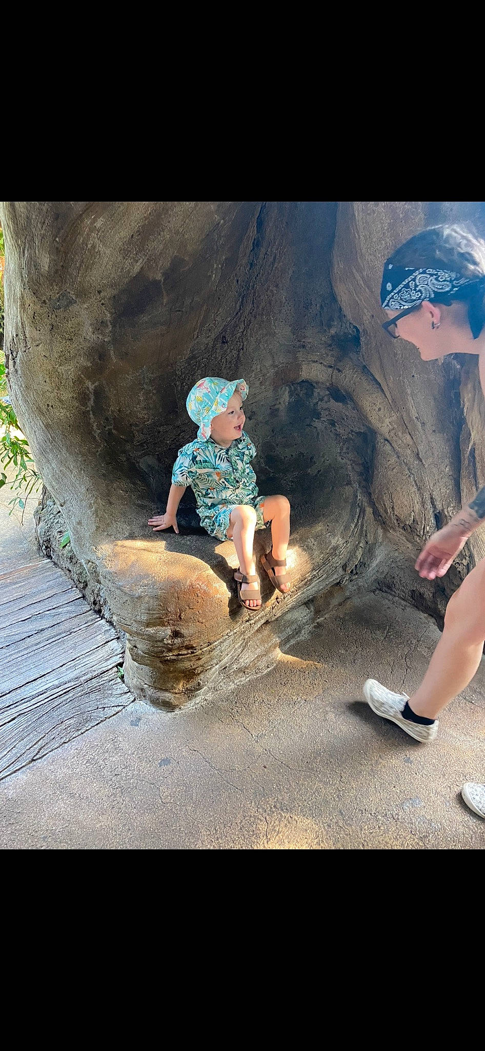 Zechariah joined the competition — help win amazing prizes! baseball_cap, cap, foot, fun, happy, hat, headwear, human_leg, landscape, leisure, people_in_nature, person, recreation, rock, sandal, shadow, shorts, sitting, soil, t_shirt