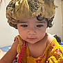 Dalia participe au concours pour gagner de l'argent avec cette photo : toddler, child, face, portrait, yellow_dress, floral_pattern, bonnet, headwear, curly_hair, indoors, soft_focus, cute, baby, person, young_child, clothing, pink_trim, skin, expression, closeup