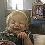Jasper is registered to the contest to win money with this photo: broccoli, child, clothing, dining, face, food, hair, happy, high_chair, home, indoor, meal, peas, person, plate, smiling, table, toddler, toy, window