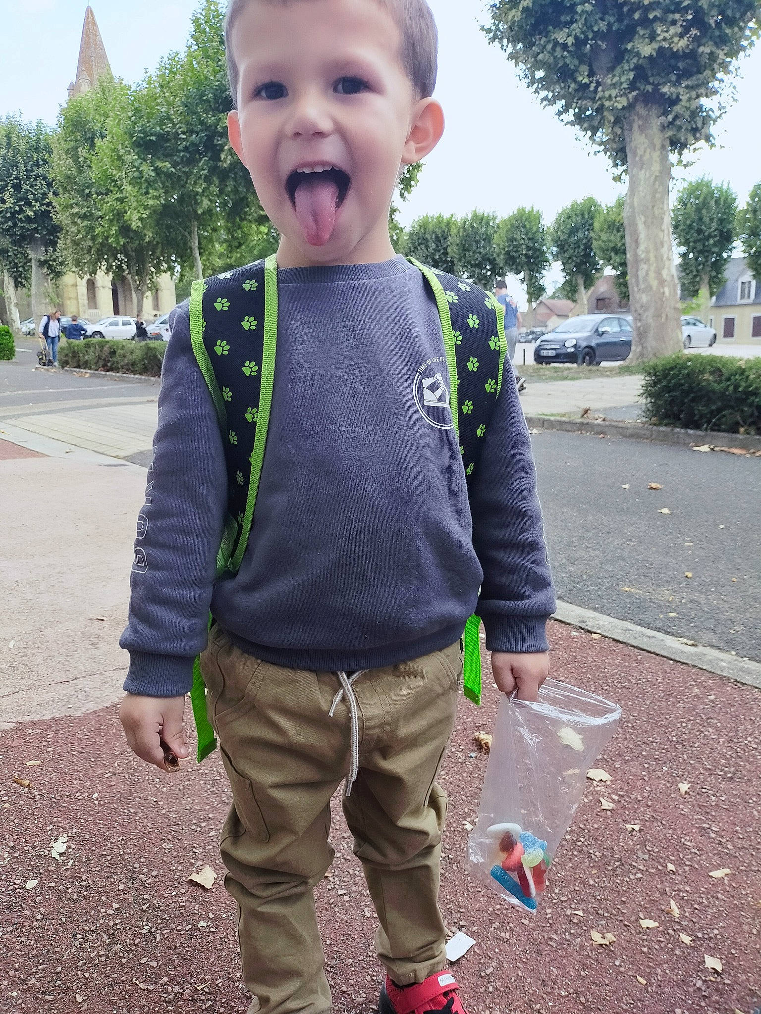 Hugo a rejoint le concours — aidez-le/la à gagner de superbes lots ! asphalt, baby_toddler_clothing, cool, daytime, eye, fun, gesture, grass, hairstyle, happy, head, human, leaf, person, plant, road_surface, sky, sleeve, summer, toddler