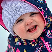 Natalie is registered to the contest to win money with this photo: baby, babylaughing, bonnet, cap, clothing, coat, face, happy, hat, head, hood, hoodie, jacket, knitwear, laughing, person, photography, portrait, smile, sweater